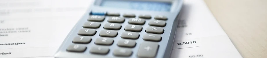 Calculator resting on financial paperwork